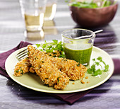 Chicken wings coated in oat flakes and herbs, rocket lettuce sauce
