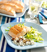 Thick piece of salmon with rice and mushrooms, aubergines and tender leeks