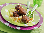 Spicy beef meatball brochettes, semolina with sultanas