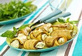 Aubergine rolls garnished with goat's cheese and pesto