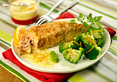 Salmon in almond crust with brocolis and orange-flavored cream sauce