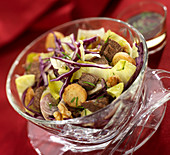 Beef bourguignon salad with red cabbage, endives, walnuts and croutons