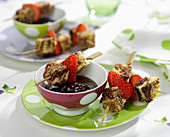Chocolate fondue with marble cake and strawberry brochettes
