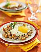 White haricot bean salad topped with a fried egg