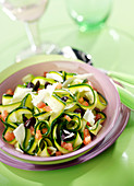 Thin strips of courgettes with black olives, tomatoes and Parmesan flakes