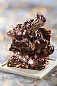 Chocolate bars with pistachios, almonds, marshmallow and fruit paste