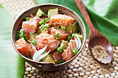 Salmon and avocado poke with peppers and sesame seeds