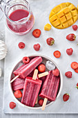 Mango-strawberry and raspberry smoothie ice pops