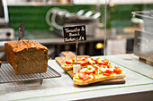 Cakes and savoury tartines on display in a coffee shop