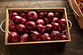Red onions in a wooden box