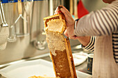 Man extracts honey from a honeycomb