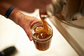 Man fills honey into jars