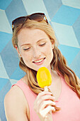 Woman eating mango ice cream on a stick