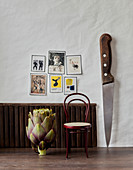 Giant knife and artichoke in a room