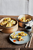 Steamed dumplings with red pepper sauce