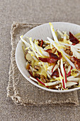 Chicory and red apple sticks,walnut and grilled bacon salad with curry sauce