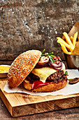 Grilled burger with cheddar cheese, mushrooms and red onions