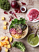 Macro Bowl mit Quinoa, Kürbispüree, Grünkohl, Zwiebeln und Sprossen