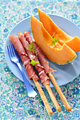 Melon With Parma Ham Rolled On Breadsticks