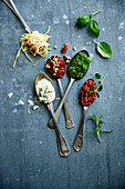 Spoons full of sauces :blue,tomato,hot tomato,walnut,pesto and Bolognaise