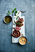 Assortment of grilled meats,green salsa and green pepper sauce
