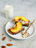 Toasted bread with almond butter, honey and peaches