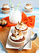 Carrot cupcakes topped with cream and walnuts