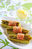 Asparagus flan topped with bundles of asparagus with salmon and sesame seeds,mousseline sauce