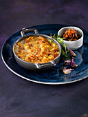 Camargue red rice with pumpkin and mushrooms, gratin of red squash with garlic cream, garlic cloves in jackets
