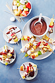 Fruit kebabs, brioche and marshmallow, chocolate sauce