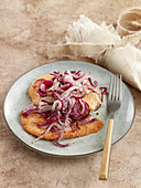Turkey escalope with stewed red onions