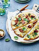 Pizza with potatoes, tomatoes and basil