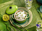 Rice in a mini cocotte pot with flavoured water with lemon and flowers
