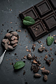 Chocolate bar and spoon with cocoa beans