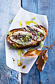 Sardine and red onion toasted sandwich with olive oil and bay leaves
