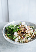 Quinoa with fish, mushrooms and spinach leaves