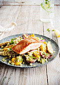 Grilled salmon on couscous with summer vegetables