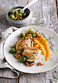 Chicken breast with carrot puree, Brussels sprouts, mushrooms and bacon
