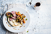 Venison fillet with parsnip puree, vegetables and roast potatoes
