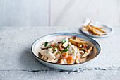 Chicken with creamy mushroom sauce served with parsnip fries