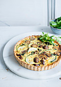 Almond pastry quiche with courgettes and mushrooms