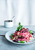 Spelt flour spaghetti with beetroot and pine nuts