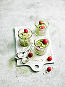 White chocolate mousse with matcha tea and fresh raspberries
