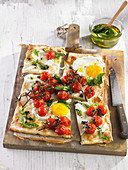 Pizza with eggs and cherry tomatoes