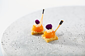 Sweet amuse-bouche with apricot jelly and violet foam