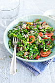 Kale salad with onions, cherry tomatoes and sunflower seeds