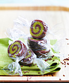 Rolled chocolate pistachio sweets in cellophane paper