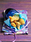 Salmon and cod nuggets shaped like fish with sesame breading