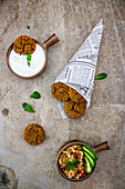 Baked falafel in a cone with a mint yoghurt dip and tabouleh