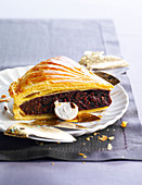 A piece of chocolate galette-des-rois (Epiphany cake, France)